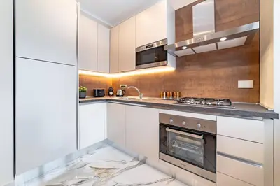 a kitchen with white cabinets and a stove at 42 Gandino Superior in Rome