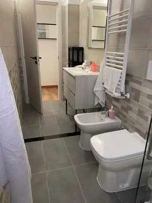 a bathroom with a toilet and a sink at Lola Holiday Home, Roma Ostiense in Rome