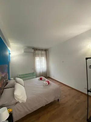 a bedroom with a large bed in a room at Lola Holiday Home, Roma Ostiense in Rome