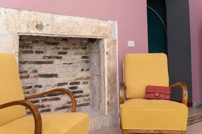 a room with two chairs and a brick fireplace at Appartamento Tor Millina 4 Piazza Navona in Rome