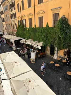 an overhead view of an outdoor market with tables and umbrellas at Appartamento Tor Millina 4 Piazza Navona in Rome