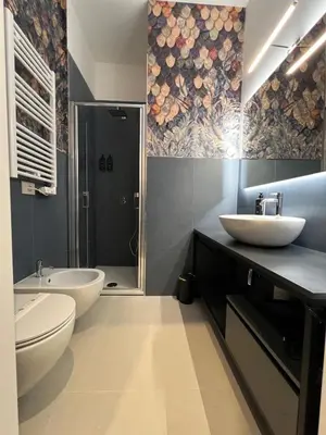 a bathroom with two sinks and a toilet and a shower at Adelaide Suite Dreams in Rome