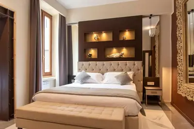 a bedroom with a large bed with a large headboard at Adelaide Suite Dreams in Rome