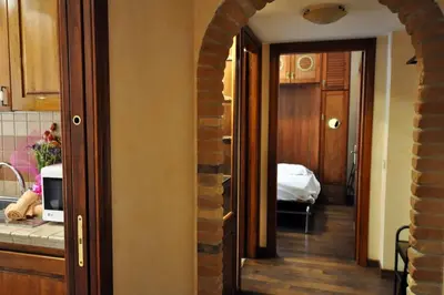a kitchen with an archway leading to a room at Le 3 Elle Vaticano San Pietro in Rome