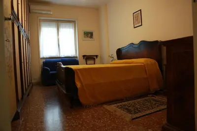 a bedroom with a bed and a chair and a window at San Peter’s Heaven’s Door in Rome