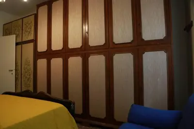 a bedroom with a large wooden wall with windows at San Peter’s Heaven’s Door in Rome