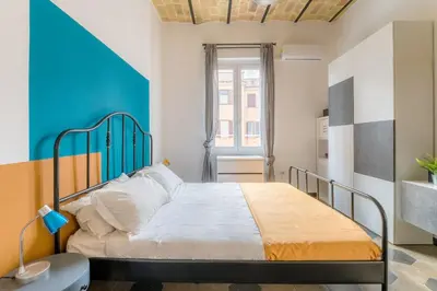 a bedroom with a bed and a blue and white wall at Casetta Giolitti, Cozy Apt in the Heart of Rome in Rome
