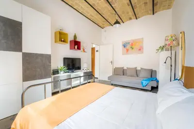 a bedroom with a bed and a couch in a room at Casetta Giolitti, Cozy Apt in the Heart of Rome in Rome