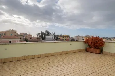 a balcony with a potted plant on top of a building at Hotel Monte Verde in Rome