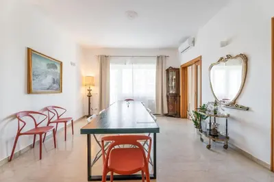 a dining room with a table and chairs and a mirror at BigFamilyRome-Vatican&Aurelio in Rome