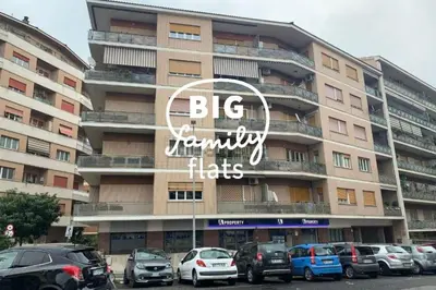 a large building with cars parked in front of it at BigFamilyRome-Vatican&Aurelio in Rome