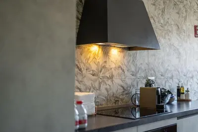a kitchen with a counter top with a hood at BigFamilyRome-Vatican&Aurelio in Rome
