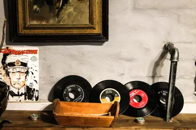 a bunch of records sitting on a shelf next to a wall at DGVatican in Rome