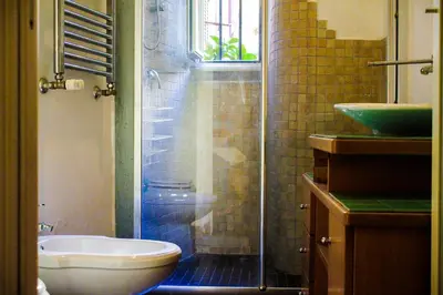 a bathroom with a shower and a toilet and a sink at DGVatican in Rome