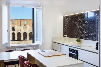 a kitchen with a window and a table and chairs at Colosseo View Atmosphere by Rental in Rome in Rome