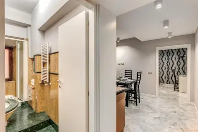 a kitchen and dining room with a tub and a table at R22 Apartment in Rome