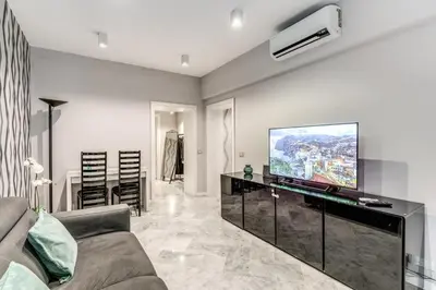 a living room with a couch and a flat screen tv at R22 Apartment in Rome