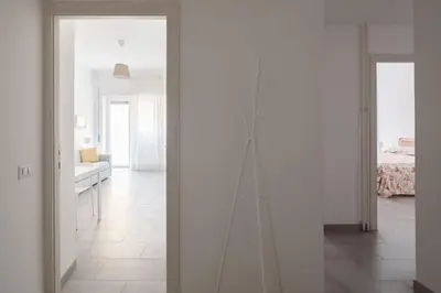 a room with white walls and a living room at Caffarella Park View Rome in Rome