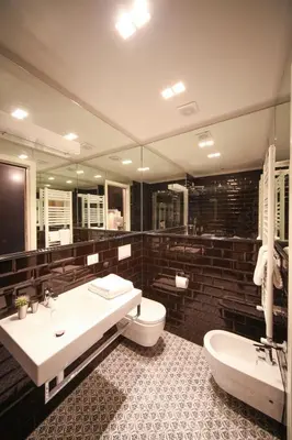 a bathroom with a sink and a toilet and a mirror at App Condotti Luxury Apartment In Rome in Rome