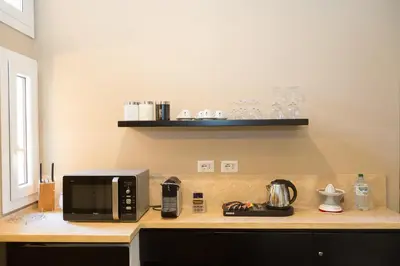 a kitchen counter with a microwave and a coffee maker on it at App Condotti Luxury Apartment In Rome in Rome