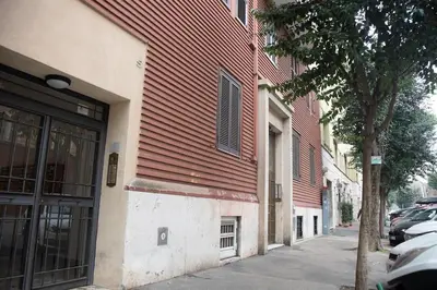 a building on a sidewalk next to a street at Locazione Turistica- Maxxi loft in Rome