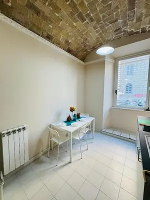 a kitchen with a table and chairs in a room at MILLE PARADISO in Rome