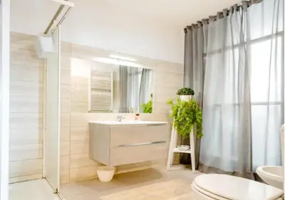 a bathroom with a sink and a toilet and a mirror at 