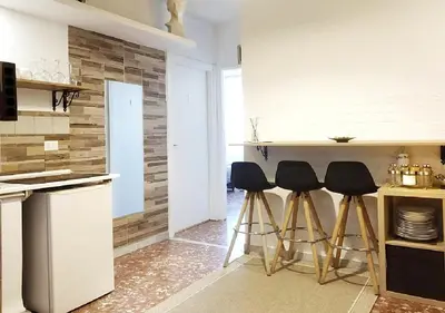 a kitchen with three bar stools in front of a counter at 