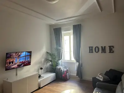 a living room with a couch and a tv at Giuliana Vatican Luxury Home in Rome