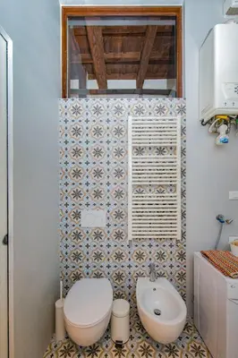 a bathroom with a toilet and a sink at FUORI dal TEMPO Roma Trastevere in Rome