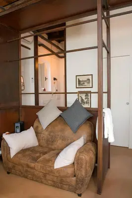 a large couch with pillows on it in a room at FUORI dal TEMPO Roma Trastevere in Rome