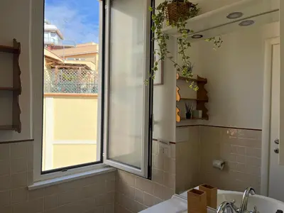 a bathroom with a window and a sink and a tub at Appartamento S. Pietro in Rome