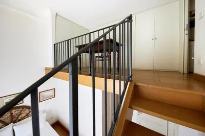 a staircase in a home with white walls and wood floors at iFlat Retro Chic Apartment in Prati in Rome
