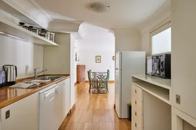 a kitchen with white cabinets and a refrigerator at iFlat Retro Chic Apartment in Prati in Rome