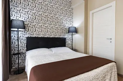 a bedroom with a large bed and a wall at B&B Residenza Gregorio VII in Rome
