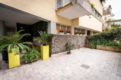 a courtyard with potted plants and a building at B&B Residenza Gregorio VII in Rome