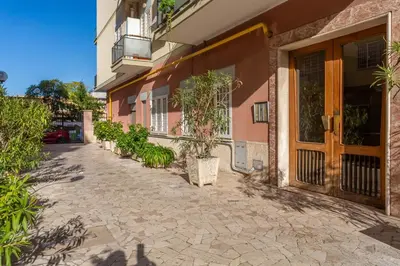 a courtyard of a building with a wooden door at 2-Bedroom Retreat near Metro & Parks in Rome