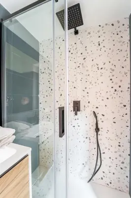 a shower with a glass door in a bathroom at FAMM Apartments - Open space in Trastevere in Rome
