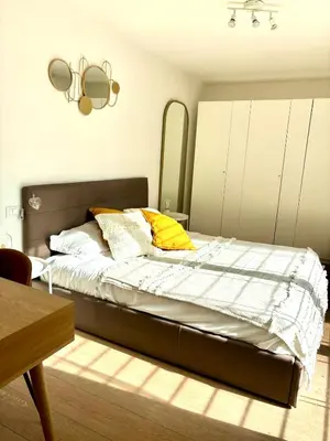 a bedroom with a bed with a mirror and a table at Matilda House EUR 4 posti letto in Rome