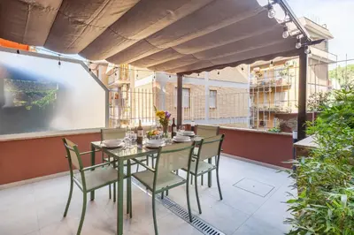a green table and chairs on a patio at Mom's home - A few stops from the city centre in Rome