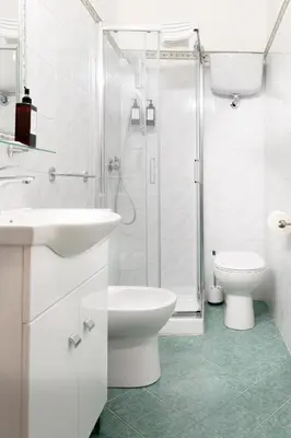 a bathroom with a toilet and a sink and a shower at Hotel Domus Rome in Rome