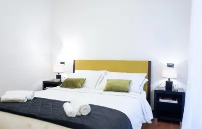 a bedroom with a large bed with towels on it at Suite 52 Trastevere in Rome