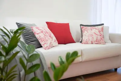 a white couch with pillows on it in a living room at Suite 52 Trastevere in Rome