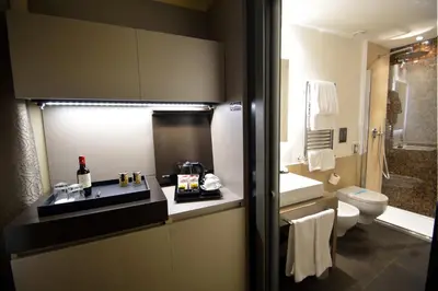 a bathroom with a sink and a toilet and a shower at Quirinale Luxury Rooms in Rome