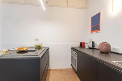 a kitchen with a large island with a counter top at PgrHome Barberini in Rome