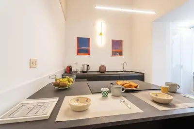 a kitchen with two bowls of fruit on a counter at PgrHome Barberini in Rome