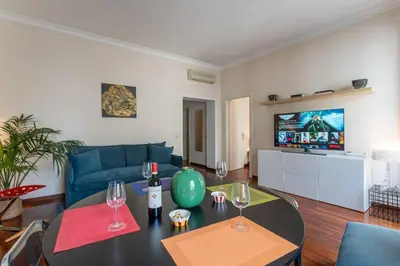 a living room with a blue couch and a table at PgrHome Barberini in Rome