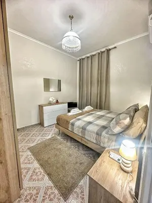 a bedroom with a bed and a table in a room at Maison Grimaldi Roma in Rome