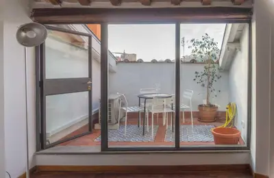 a room with a glass door with a table and a dining room at Lusso e panorama senza paragoni, Loft Trastevere in Rome