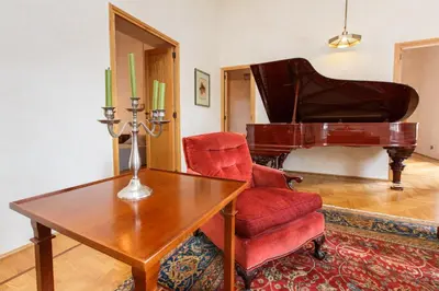 a living room with a table and a piano at Habitat's Navona 4BR Apartment in Rome